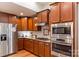 Modern kitchen featuring stainless steel appliances, granite countertops, and wooden cabinets at 1680 Beleek Ridge Ln, Clover, SC 29710