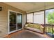 Cozy screened-in porch with wooden floors and a swing for relaxing outside at 1680 Beleek Ridge Ln, Clover, SC 29710