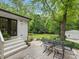 Outdoor living with patio, fire pit, and seating surrounded by lush greenery at 1714 Edgewater Dr, Charlotte, NC 28210