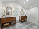 Elegant bathroom featuring double vanities with granite countertops, modern fixtures, and a glass-enclosed shower at 1714 Edgewater Dr, Charlotte, NC 28210