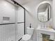 Modern bathroom with glass-enclosed shower, white subway tile, and stylish vanity area is move-in ready at 1714 Edgewater Dr, Charlotte, NC 28210