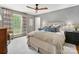 Cozy bedroom with a large window and gray walls features hardwood floors and neutral decor at 1714 Edgewater Dr, Charlotte, NC 28210