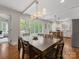Dining room with hardwood floors, neutral walls, stylish chandelier, and view of the modern white kitchen at 1714 Edgewater Dr, Charlotte, NC 28210