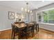 Elegant dining room with hardwood floors, neutral walls, and a stylish chandelier over a wooden table at 1714 Edgewater Dr, Charlotte, NC 28210