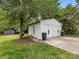 Detached two-car garage, accentuated by landscaping, in a serene backyard setting at 1714 Edgewater Dr, Charlotte, NC 28210