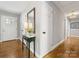 Bright hallway with hardwood floors, natural light, and neutral paint is move-in ready at 1714 Edgewater Dr, Charlotte, NC 28210