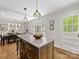 Open kitchen featuring a central island, white cabinets, hardwood floors and window views looking to the outdoors at 1714 Edgewater Dr, Charlotte, NC 28210