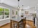 Bright kitchen with hardwood floors, white cabinetry, a central island, and stainless-steel appliances at 1714 Edgewater Dr, Charlotte, NC 28210