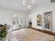 Bright living room with vaulted ceilings, checkerboard rug, and French doors offers ample space to live at 1714 Edgewater Dr, Charlotte, NC 28210