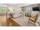 Cozy living room featuring hardwood floors, neutral walls, built-in shelving, and a comfortable seating arrangement at 1714 Edgewater Dr, Charlotte, NC 28210