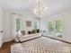 Bright living room with vaulted ceilings, checkerboard rug, and large windows offers space for entertainment at 1714 Edgewater Dr, Charlotte, NC 28210