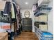 Well-organized walk-in closet features ample storage with custom shelves and hanging rods and hardwood floor at 1714 Edgewater Dr, Charlotte, NC 28210