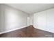 This bedroom has hardwood floors, a built-in wardrobe, and neutral walls at 2200 Lyndhurst Ave # 203, Charlotte, NC 28203