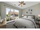 Staged bedroom with large window, ceiling fan, decor, and a comfy-looking bed at 2200 Lyndhurst Ave # 203, Charlotte, NC 28203