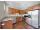 Open kitchen features wood cabinetry, stainless steel appliances, and granite countertops at 2200 Lyndhurst Ave # 203, Charlotte, NC 28203