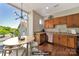 Sunlit eat-in kitchen features wood cabinets, granite countertops, and stainless steel appliances at 2200 Lyndhurst Ave # 203, Charlotte, NC 28203