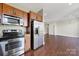 Open kitchen with stainless steel appliances and wooden cabinets, great for entertaining at 2200 Lyndhurst Ave # 203, Charlotte, NC 28203