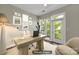 Staged office with natural light, hardwood floors, desk, and balcony access at 2200 Lyndhurst Ave # 203, Charlotte, NC 28203
