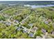 Residential aerial view showing neighborhood homes and surrounding wooded areas near a lake at 2620 Shady Reach Ln, Charlotte, NC 28214