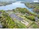 Aerial view of a boat and RV parking lot, near a lake, surrounded by trees at 2620 Shady Reach Ln, Charlotte, NC 28214