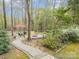 Secluded backyard oasis featuring a fire pit, lush landscaping, and charming patio area perfect for outdoor entertaining at 2620 Shady Reach Ln, Charlotte, NC 28214