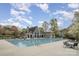 Community pool and clubhouse with ample seating, offering residents a refreshing outdoor recreation space at 2620 Shady Reach Ln, Charlotte, NC 28214