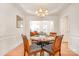 Bright dining room with wainscoting, chandelier, seating for four, and an open layout at 2620 Shady Reach Ln, Charlotte, NC 28214