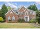 Charming brick two-story home with manicured lawn, symmetrical design and welcoming entrance at 2620 Shady Reach Ln, Charlotte, NC 28214