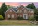Beautiful brick two-story home featuring a manicured lawn and a classic architectural design at 2620 Shady Reach Ln, Charlotte, NC 28214