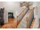 Elegant foyer with hardwood floors, staircase and view of a home office at 2620 Shady Reach Ln, Charlotte, NC 28214