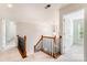 Upstairs hallway with wood banister, carpet, and natural light, connecting bedrooms and living spaces for seamless flow at 2620 Shady Reach Ln, Charlotte, NC 28214