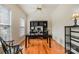 Dedicated home office with wood floors, large desk, built-in shelving, and ample natural light for productive work at 2620 Shady Reach Ln, Charlotte, NC 28214