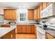 Well-equipped kitchen with modern appliances, wood cabinetry, and a window view at 2620 Shady Reach Ln, Charlotte, NC 28214