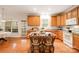 Open kitchen with an island and wood cabinets offer a seamless flow to the dining area at 2620 Shady Reach Ln, Charlotte, NC 28214