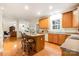 Open kitchen with an island, ample cabinetry, and hardwood floors is great for entertaining at 2620 Shady Reach Ln, Charlotte, NC 28214
