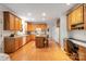 Expansive kitchen featuring an island, plenty of cabinets, and an adjacent office space at 2620 Shady Reach Ln, Charlotte, NC 28214