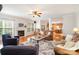 Inviting living room showcasing a fireplace, ceiling fan, natural light and an open floor plan at 2620 Shady Reach Ln, Charlotte, NC 28214