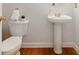 Charming powder room with pedestal sink, gold fixtures, and a clean, modern aesthetic, conveniently located for guests at 2620 Shady Reach Ln, Charlotte, NC 28214