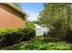 Private backyard with gate, lush greenery, and partial views of the lake at 273 Leeward Point Loop # 14, Taylorsville, NC 28681