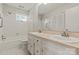All white bathroom with double vanity, tile floor, and shower-tub combo offers a classic appeal at 273 Leeward Point Loop # 14, Taylorsville, NC 28681