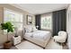 An inviting bedroom with neutral tones, features natural light, accent lighting and a cozy chair at 273 Leeward Point Loop # 14, Taylorsville, NC 28681