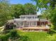 Rear view showcasing a spacious deck, brick accents, and well-manicured lawn at 273 Leeward Point Loop # 14, Taylorsville, NC 28681