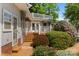 Exterior view highlighting the wooden deck and stairs, as well as the lush surrounding landscaping at 273 Leeward Point Loop # 14, Taylorsville, NC 28681