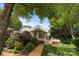 Charming home exterior featuring a landscaped yard, wooden walkway, and a balcony with striped awnings at 273 Leeward Point Loop # 14, Taylorsville, NC 28681