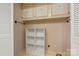 The laundry room features cabinets above a shelving unit and patterned wallpaper at 273 Leeward Point Loop # 14, Taylorsville, NC 28681