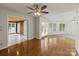 The spacious living room features wood floors, large windows, and seamless transitions to the sunroom at 273 Leeward Point Loop # 14, Taylorsville, NC 28681