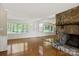 Bright living room features a stone fireplace, mirrored wall, and gleaming hardwood floors at 273 Leeward Point Loop # 14, Taylorsville, NC 28681