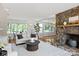Beautiful living room boasts a stone fireplace and large windows offering scenic views at 273 Leeward Point Loop # 14, Taylorsville, NC 28681