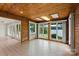 This sunroom offers panoramic lake views through large windows and features a unique wooden ceiling and tile flooring at 273 Leeward Point Loop # 14, Taylorsville, NC 28681