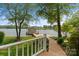 Picturesque waterfront view showcasing a boathouse, wooden walkway, and well-maintained landscaping at 273 Leeward Point Loop # 14, Taylorsville, NC 28681